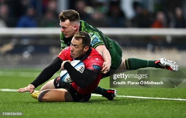 Galway , Ireland - 23 March 2024; Erich Cronje of Emirates Lions scores his side's fourth try despite pressure from David Hawhshaw of Connacht during...