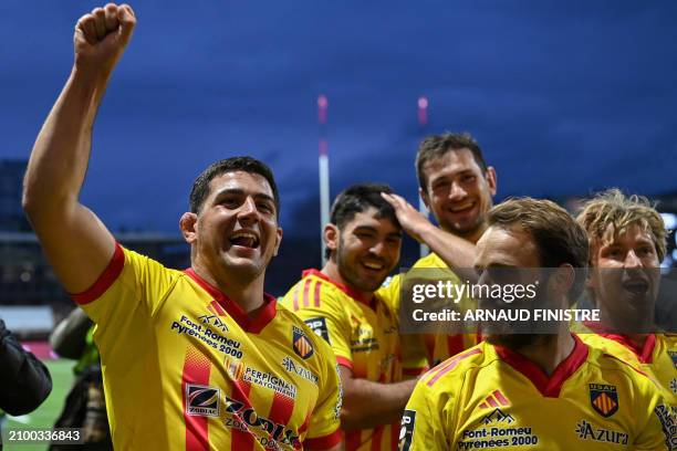 Perignan's players celebrate their team's victory at the end of the French Top14 rugby union match between Union Sportive Oyonnax Rugby and USA...