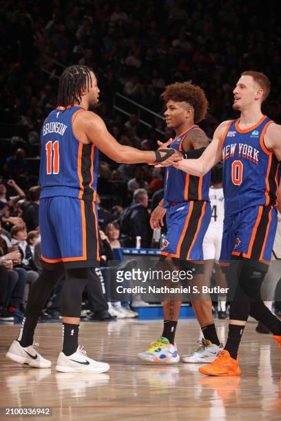 Donte Divincenzo and Jalen Brunson of the New York Knicks celebrate during the game against the Brooklyn Nets on March 23, 2024 at Madison Square...