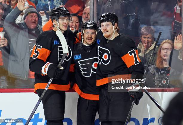 Travis Konecny of the Philadelphia Flyers celebrates his third period goal against the Boston Bruins with Egor Zamula and Owen Tippett at the Wells...