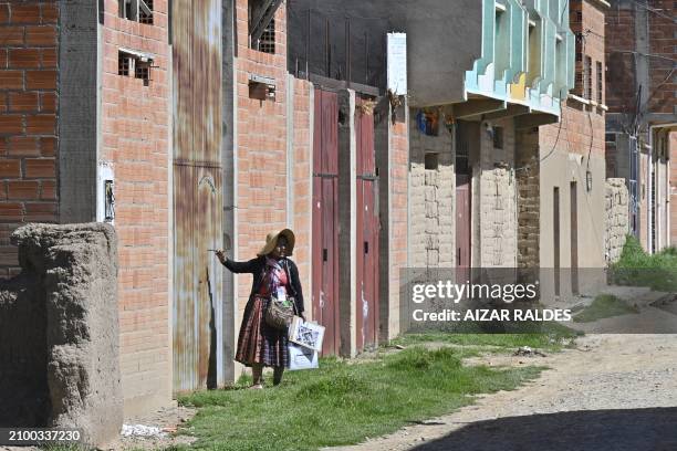 Volunteer census taker knocks on a door in Laja, Bolivia on March 23, 2024.