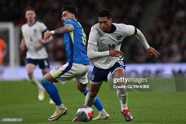 England's midfielder Jude Bellingham vies with Brazil's midfielder Lucas Paqueta during the international friendly football match between England and...