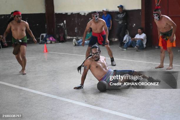 An indigenous man kicks the ball during a Mayan ball game match in Tecpan, Guatemala on March 23, 2024. Dressed in shorts, girdle and uncovered...