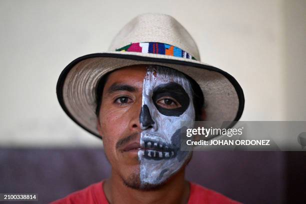 Player Maximo Garcia poses for a picture after a Mayan ball game match in Tecpan, Guatemala, on March 23, 2024. . Dressed in shorts, girdle and...