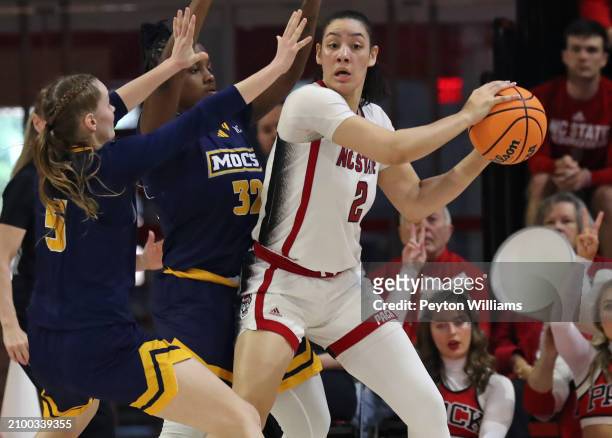 Mimi Collins of the North Carolina State Wolfpack is pressured by Sigrun Olafsdottir and Raven Thompson of the Chattanooga Lady Mocs during the first...