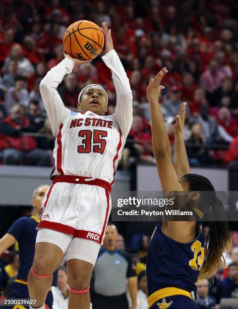 Zoe Brooks of the North Carolina State Wolfpack shoots against Jada Guinn of the Chattanooga Lady Mocs during the first round of the 2024 NCAA...