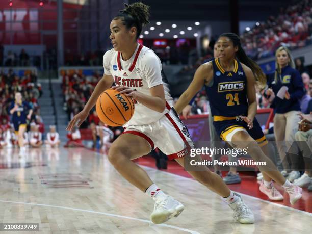 Madison Hayes of the North Carolina State Wolfpack drives against Addie Porter of the Chattanooga Lady Mocs during the first round of the 2024 NCAA...