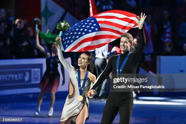 Madison Chock and Evan Bates of the United States skate around the rink after competing and winning gold in the Ice Dance Free Dance during the ISU...