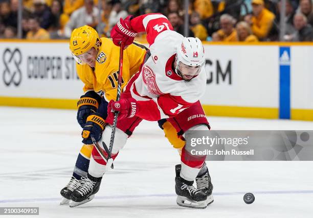 Robby Fabbri of the Detroit Red Wings skates against Gustav Nyquist of the Nashville Predators during an NHL game at Bridgestone Arena on March 23,...