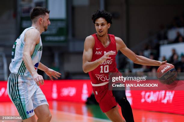 Bourg-en-Bresse's French forward Zaccharie Risacher dribbles the ball past Nanterre's Bastien Pinault during the French Ligue Nationale de Basket Pro...