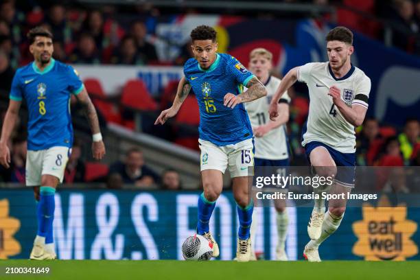 Joao Gomes of Brazil is chased by Declan Rice of England during the international friendly match between England and Brazil at Wembley Stadium on...