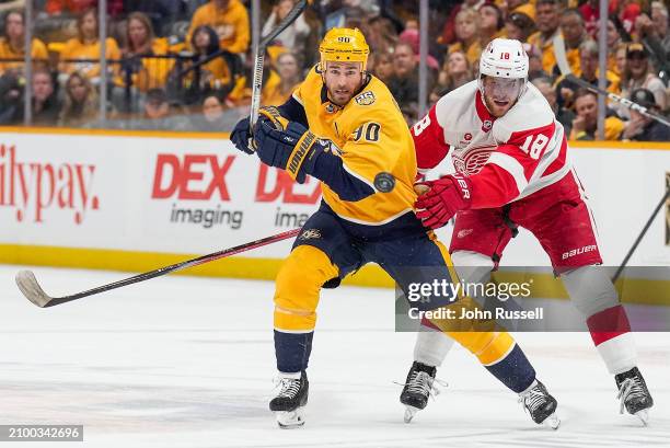 Ryan O'Reilly of the Nashville Predators battles for the puck against Andrew Copp of the Detroit Red Wings during an NHL game at Bridgestone Arena on...