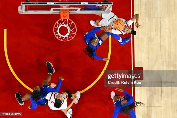 JuJu Watkins of the USC Trojans is fouled while going to the basket by Nabaweeyah McGill of the Texas A&M Corpus Christi Islanders during the first...