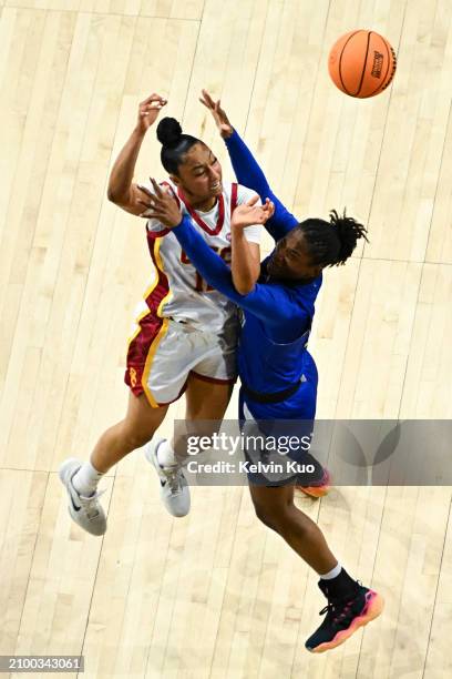JuJu Watkins of the USC Trojans passes the ball while Paige Allen of the Texas A&M Corpus Christi Islanders defends during the first round of the...