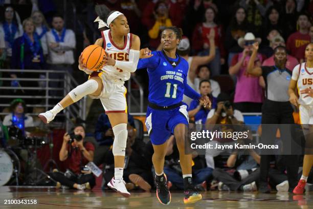 Kayla Williams of the USC Trojans reaches for a pass in front of Paige Allen of the Texas A&M-CC Islanders in the first half during the NCAA Women's...