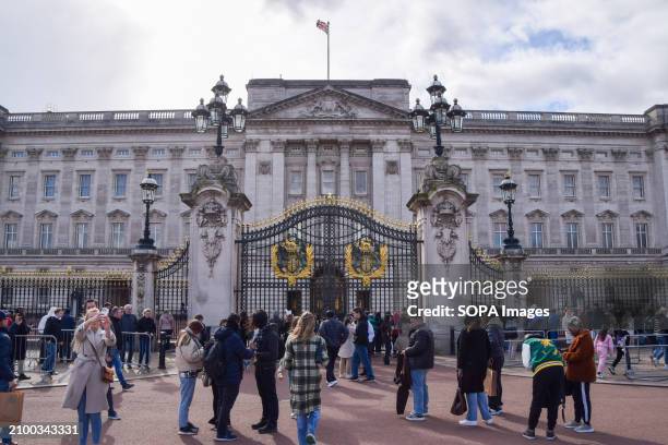 Crowds gather outside Buckingham Palace following the announcement that Catherine, Princess of Wales, has been diagnosed with cancer.