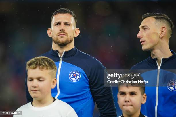 Martin Dubravka and Robert Bozenik of Slovakia stand for the national anthem prior to the international friendly match between Slovakia and Austria...