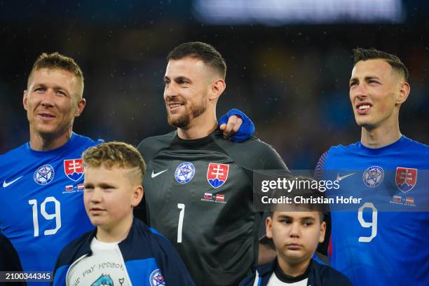 Juraj Kucka, goalkeeper Martin Dubravka and Robert Bozenik of Slovakia stand for the national anthem prior to the international friendly match...