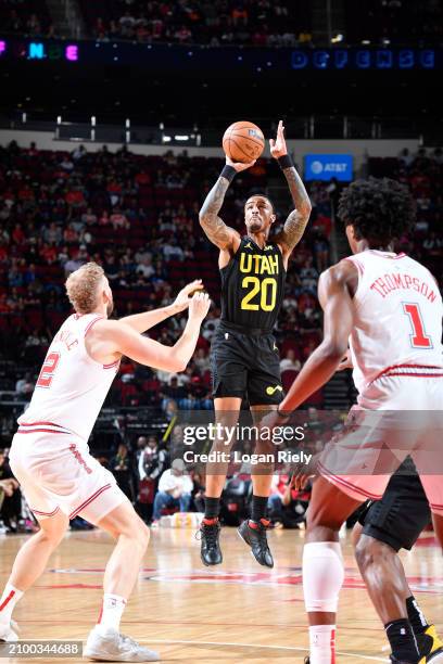 John Collins of the Utah Jazz shoots a three point basket against the Houston Rockets on March 23, 2024 at the Toyota Center in Houston, Texas. NOTE...