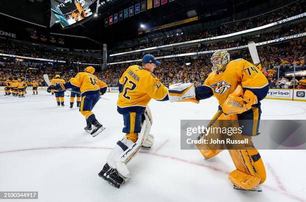 Kevin Lankinen congratulates Juuse Saros of the Nashville Predators on a 1-0 win against the Detroit Red Wings during an NHL game at Bridgestone...