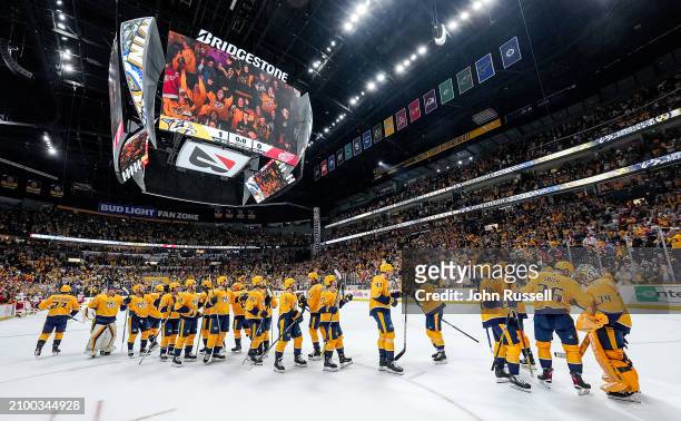 The Nashville Predators celebrate a 1-0 win against the Detroit Red Wings during an NHL game at Bridgestone Arena on March 23, 2024 in Nashville,...