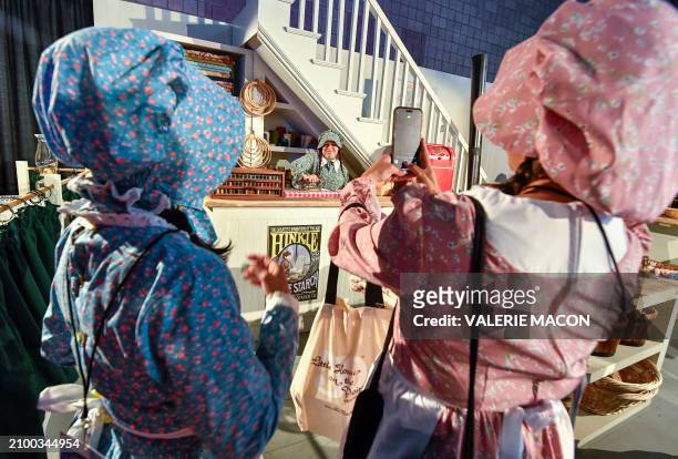 Fans pose for photos in a reproduction of the set of "Oleson's Mercantile" general store during "The Little House on the Prairie" 50th anniversary...