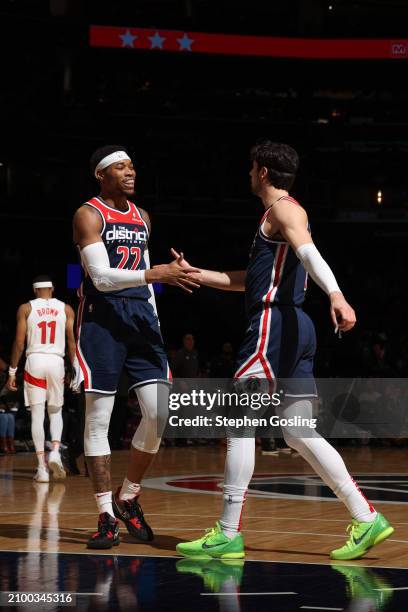 Richaun Holmes of the Washington Wizards & Deni Avdija of the Washington Wizards high five during the game on March 23, 2024 at Capital One Arena in...