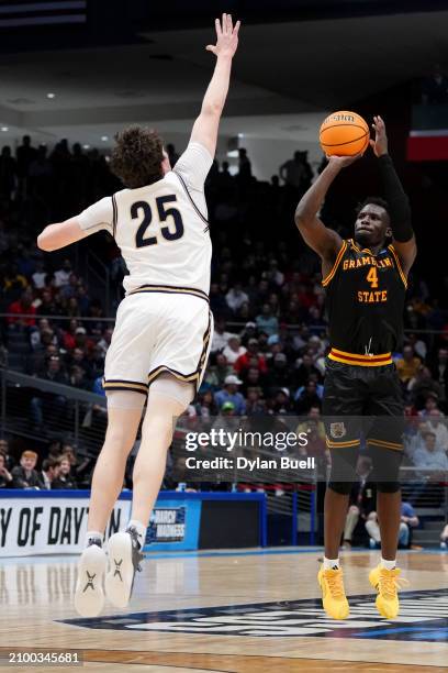 Antwan Burnett of the Grambling State Tigers shoots a three point basket against Sam Lecholat of the Montana State Bobcats during the first half in...