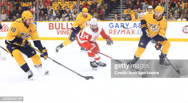 Detroit Red Wings winger Robby Fabbri defends between Nashville Predators center Ryan O'Reilly and defenseman Ryan McDonagh during the NHL game...