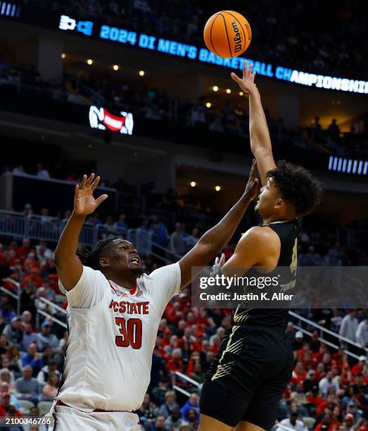 Trey Townsend of the Oakland Golden Grizzlies puts up a shot over DJ Burns Jr. #30 of the North Carolina State Wolfpack in the second half during the...