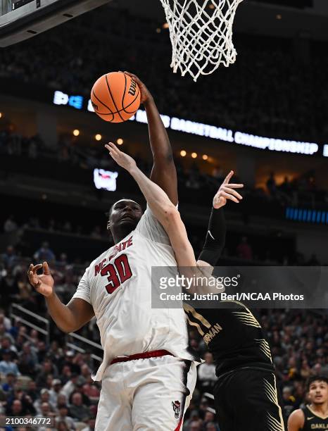 Burns Jr. #30 of the North Carolina State Wolfpack goes to the basket against Blake Lampman of the Oakland Golden Grizzlies in the second half during...
