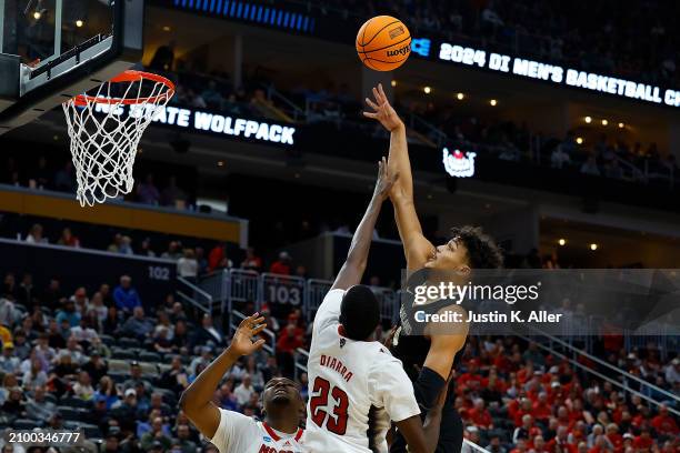 Trey Townsend of the Oakland Golden Grizzlies puts up a shot over Mohamed Diarra of the North Carolina State Wolfpack in the second half during the...