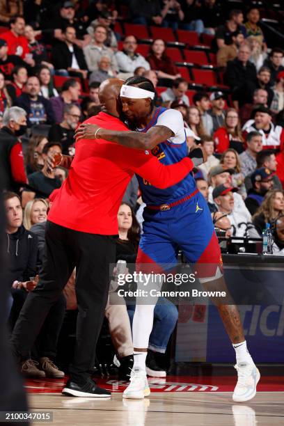 Head Coach Chauncey Billups of the Portland Trail Blazers and Kentavious Caldwell-Pope of the Denver Nuggets embrace before the game on March 23,...