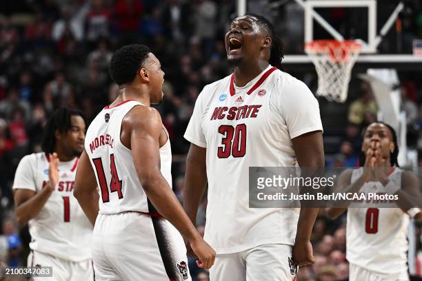Burns Jr. #30 of the North Carolina State Wolfpack celebrates with Casey Morsell after a basket in overtime of the game against the Oakland Golden...
