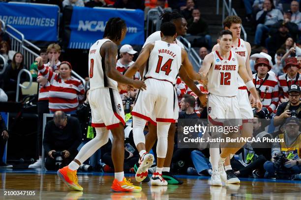 Michael O'Connell of the North Carolina State Wolfpack celebrates with teammates after a basket in the second half of the game against the Oakland...