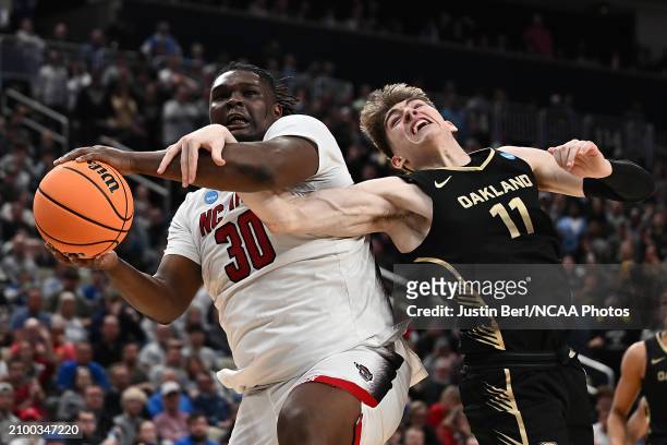 Burns Jr. #30 of the North Carolina State Wolfpack is fouled by Blake Lampman of the Oakland Golden Grizzlies in the second half during the second...