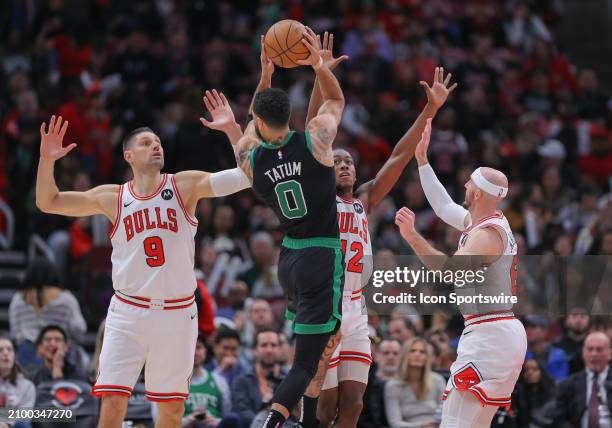 Jayson Tatum of the Boston Celtics is tripled teamed by Nikola Vucevic of the Chicago Bulls Ayo Dosunmu of the Chicago Bulls and Alex Caruso of the...