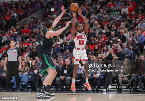 Ayo Dosunmu of the Chicago Bulls shoots a 3-point basket during the second half against the Boston Celtics at the United Center on March 23, 2024 in...