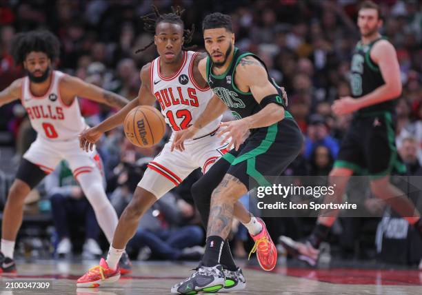 Ayo Dosunmu of the Chicago Bulls and Jayson Tatum of the Boston Celtics in action during the second half at the United Center on March 23, 2024 in...