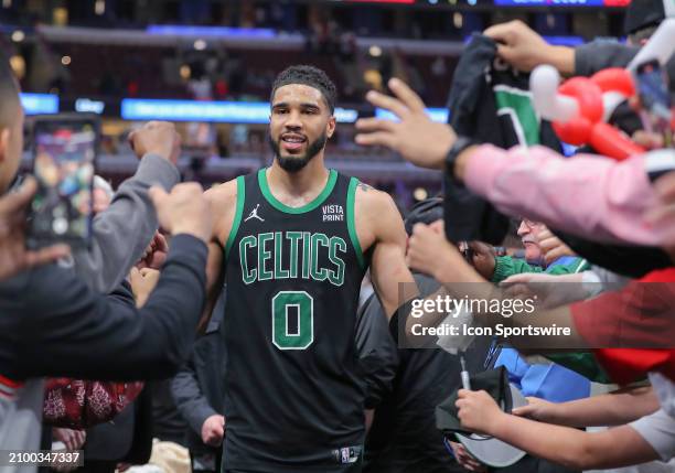 Jayson Tatum of the Boston Celtics high fives fans as he walks back to the locker room after a game against the Chicago Bulls at the United Center on...