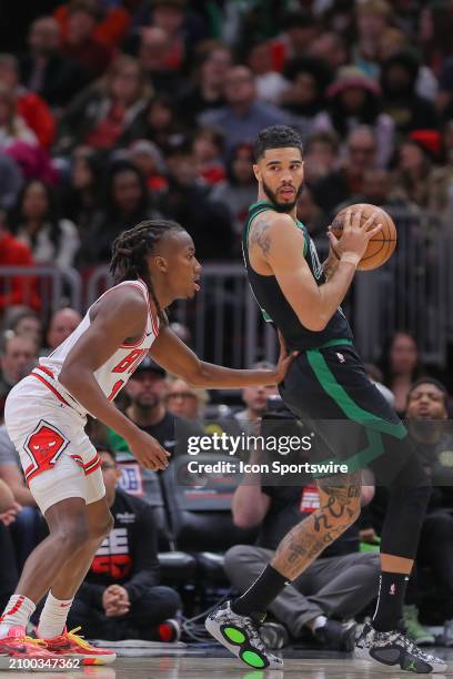 Ayo Dosunmu of the Chicago Bulls posts up against Jayson Tatum of the Boston Celtics during the second half at the United Center on March 23, 2024 in...