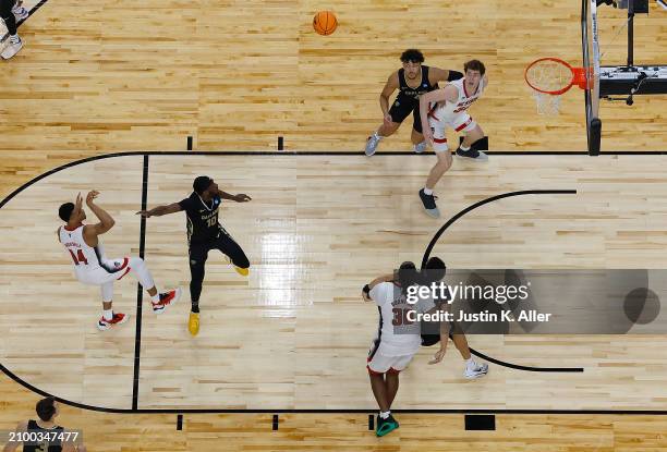 Casey Morsell of the North Carolina State Wolfpack puts up a shot over DQ Cole of the Oakland Golden Grizzlies in the second half during the second...