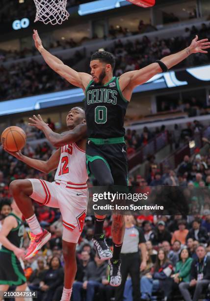 Jayson Tatum of the Boston Celtics contends Ayo Dosunmu of the Chicago Bulls layup during the second half at the United Center on March 23, 2024 in...