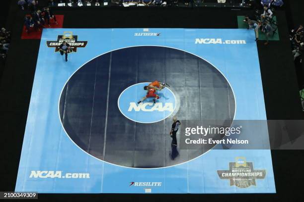 Vito Arujau of the Cornell University Big Red competes against Daton Fix of the Oklahoma State University Cowboys in the 133-pound class during the...
