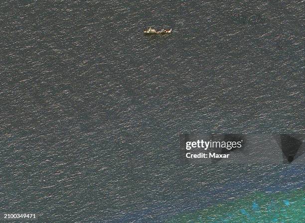 Maxar satellite imagery closer view of Chinese maritime militia vessel with barrier to entrance of Second Thomas Shoal. Please use: Satellite image...