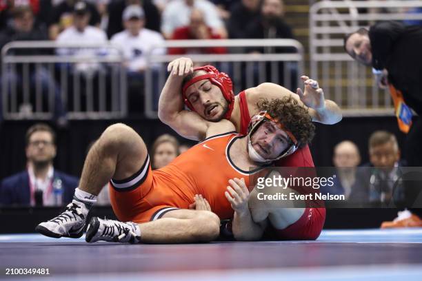 Vito Arujau of the Cornell University Big Red wrestles Daton Fix of the Oklahoma State University Cowboys during the Division I Men's Wrestling...