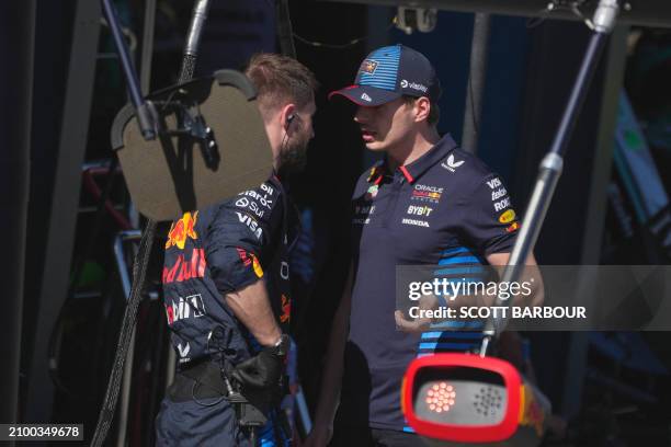 Red Bull Racing's Dutch driver Max Verstappen talks to his crew member during the Australian Formula One Grand Prix at Albert Park Circuit in...