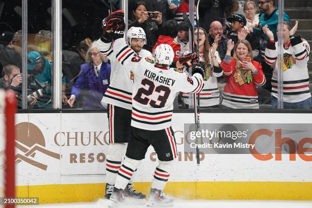 Seth Jones and Philipp Kurashev of the Chicago Blackhawks celebrate the game-winning goal in overtime against the San Jose Sharks at SAP Center on...