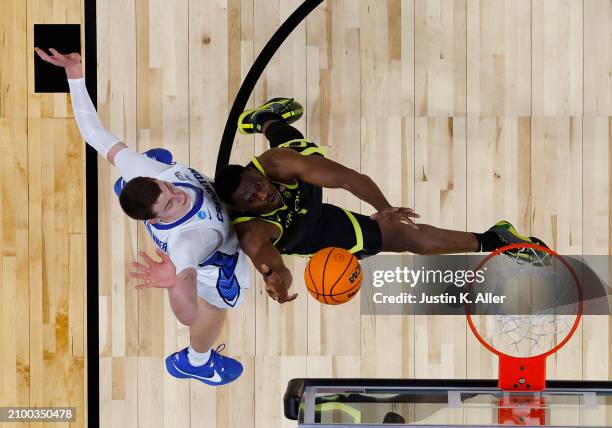 Faly Dante of the Oregon Ducks goes for a rebound against Ryan Kalkbrenner of the Creighton Bluejays in the first half during the second round of the...