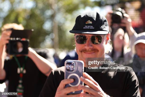 Valtteri Bottas of Finland and Stake F1 Team Kick Sauber takes a photo as he arrives at the circuit during previews ahead of the F1 Grand Prix of...